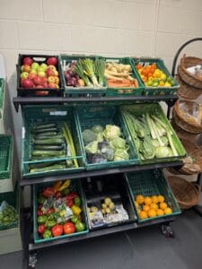 A set of shelves containing fruit and veg